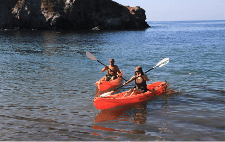 a women and a child kayaking in the waters of the little harbor campground on catalina island